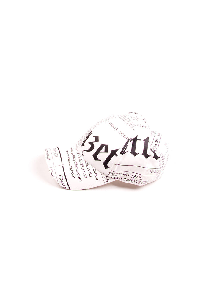 John Galliano Newspaper Print Cap in White - irvrsbl